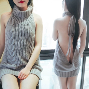 Macro detail of grey cable-knit turtleneck sleeveless midi dress with open back design