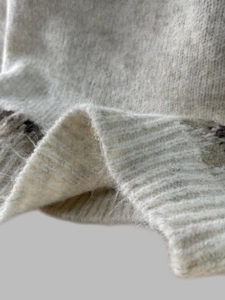 Close-up of soft Fair Isle knit texture with fuzzy mohair fibers and geometric patterns