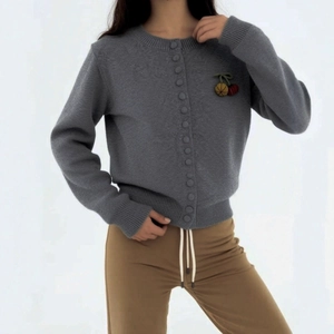 Grey knit cardigan with cherry embroidery and ribbed cuffs on light background