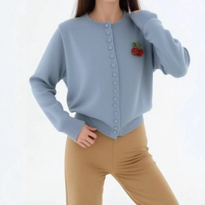 Light blue knit cardigan with cherry accents and ribbed cuffs in casual loose fit