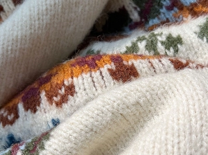 Close-up of Fair Isle knit sweater showing vintage colorful patterns and wool texture