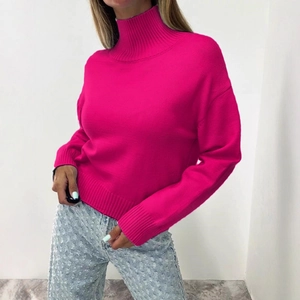 Women's fuchsia high neck oversized knit sweater paired with light blue denim jeans