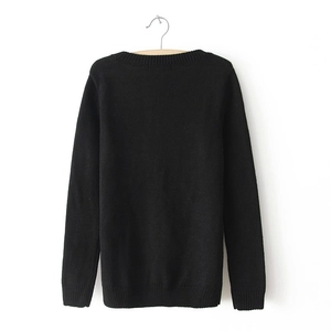 Detail view of the ribbed cuffs and hem on a black crew neck long sleeve sweater