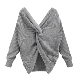 Detail showing grey chunky knit texture and back twist cross design of the loose sweater