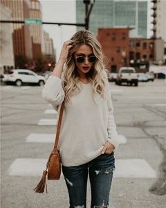 Detailed texture of thick beige oversized knit sweater with chunky cable stitching