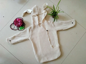 Close-up of baby knitted hoodie with cute 3D bunny ears and soft buttoned details