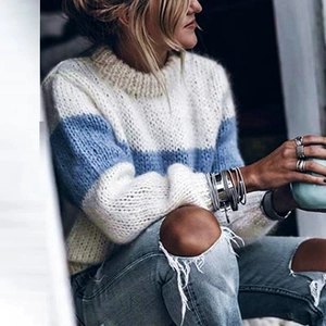 Detail of loose knit mohair sweater with fuzzy blue and cream stripes in casual style