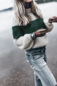 Detailed view of the chunky knit texture and wide green stripe on white mohair sweater