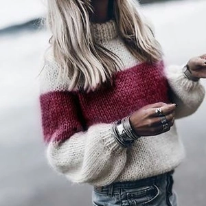 Detail of loose knit mohair sweater with burgundy stripes and puff sleeve texture