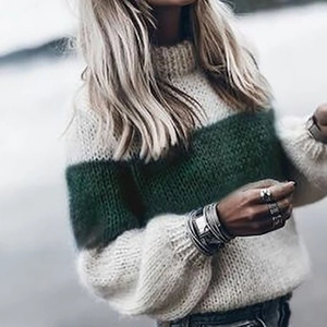 Detail of soft mohair knit texture and green striped pattern on the loose casual sweater