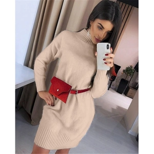 Detail of apricot turtleneck knit dress texture with a red belt and mini envelope waist bag