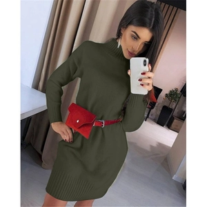 Detail of dark green knit mini dress featuring a high neck and red belt bag