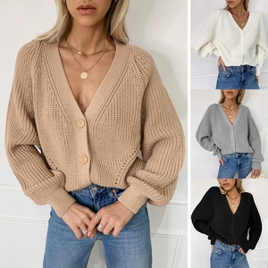 Detail view of V-neck knit cardigan with puff sleeves and large buttons in four colors