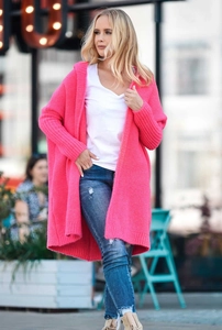 Detail of rose red oversized hooded knit cardigan featuring thick ribbed cuffs and hem