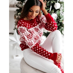 Detailed knit texture and snowflake jacquard pattern on a red festive Christmas sweater