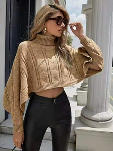 Detail of camel high-neck cable-knit poncho sweater with batwing sleeves and cropped fit
