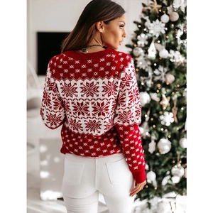 Detail of red and white Christmas sweater featuring classic snowflake knit patterns and texture