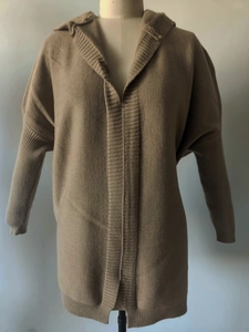 Detail view of the fine knit texture and ribbed cuffs on this loose hooded cardigan