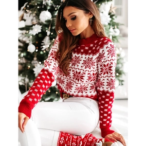 Detail of Christmas snowflake knit sweater with festive Nordic pattern and ribbed crew neck