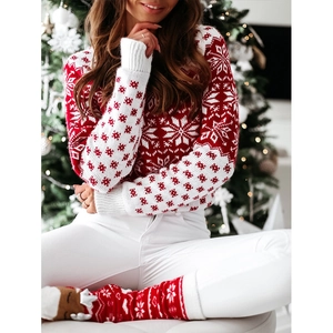 Detailed knit pattern of a festive red Christmas sweater with white snowflake motifs