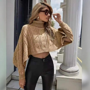 Women's camel cable knit turtleneck poncho sweater with batwing sleeves in loose fit style