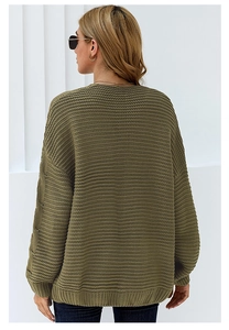 Detail view of olive green oversized knit cardigan showing ribbed cuffs and texture