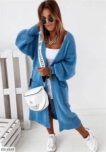 Close-up detail of light blue chunky knit cardigan with pockets and mohair texture