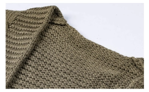 Detailed close-up of olive green cable knit sweater texture and premium ribbed neckline