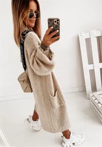 Detail showing oversized knit cardigan texture and functional side pockets in beige color