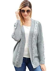 Close-up of thick cable knit texture and ribbed cuffs on light grey cardigan