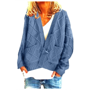 Detail of blue cable knit cardigan featuring premium v-neckline and large front pockets