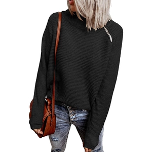 Detail of black knit sweater featuring shoulder zipper and ribbed texture surface