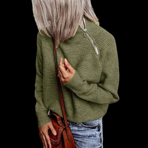 Close-up of olive green knit sweater featuring a stylish silver ring zipper detail