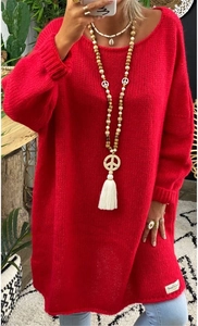 Detail of red oversized knit sweater with crew neck and ribbed cuffs in soft mohair texture