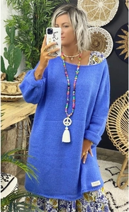 Close-up of oversized Klein blue chunky knit sweater with round neck and brand tag