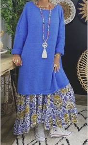 Detail view of a loose blue knitted sweater with a bohemian floral maxi skirt