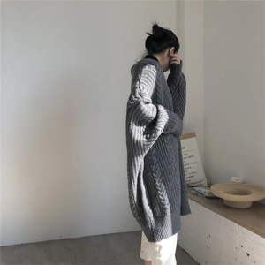 Detailed close-up of grey cable-knit texture and loose-fit sleeve on women cardigan