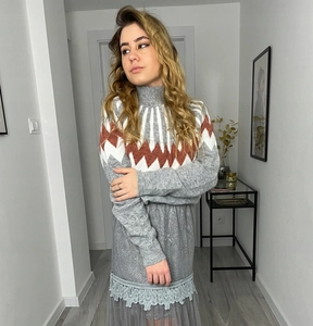 Detailed view of the grey Fair Isle knit sweater neckline with geometric patterns