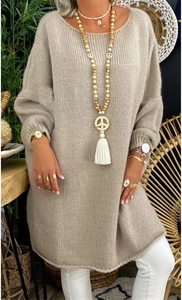Detail of oversized oatmeal knit sweater featuring cozy plush texture and boho necklaces