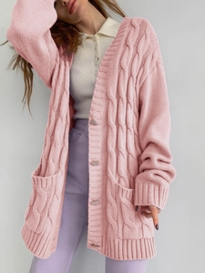 Detailed cable knit pattern on pink oversized cardigan with heart buttons