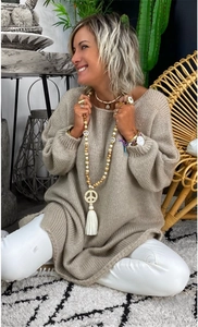 Cozy oversized khaki knit sweater detail with a warm bohemian interior home atmosphere