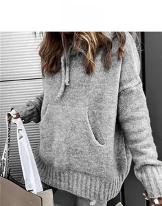 Macro detail of a grey knitted hoodie featuring a kangaroo pocket and ribbed texture