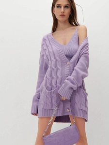 Detail of purple knit cardigan with heart buttons and cable stitch texture with matching top
