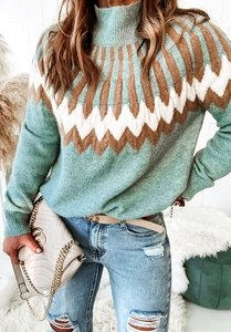 Detail of mint green turtleneck sweater featuring white and brown geometric jacquard pattern