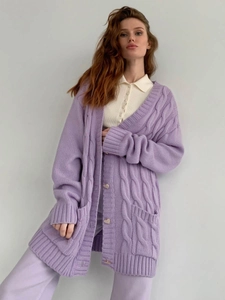 Detail of lavender knit cardigan featuring silver heart buttons and cable knit texture