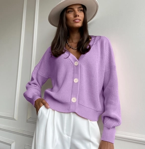 Close-up of lavender knit cardigan featuring vertical ribbing and large ivory buttons