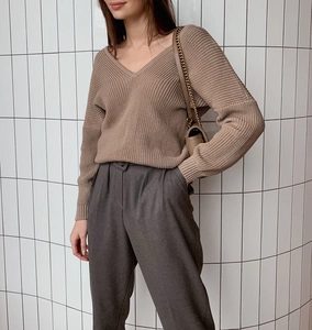 Detail of mocha brown V-neck rib-knit sweater showing texture and loose fit comfort