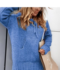 Close-up of royal blue knitted hoodie featuring kangaroo pocket and ribbed cuffs