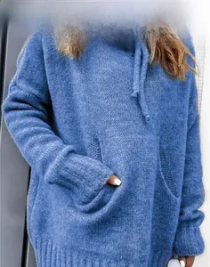 Detail of blue knitted hoodie featuring a kangaroo pocket and ribbed cuffs