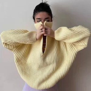 Loose knit sweater with high neck half-zipper in pale yellow featuring drop shoulders